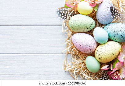Colorful Easter eggs on white wooden background.  Easter holiday concept, flat lay, top view.