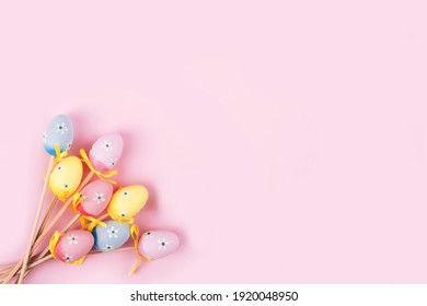 Colorful Easter Eggs Over Pink Background. Top View With Copy Space