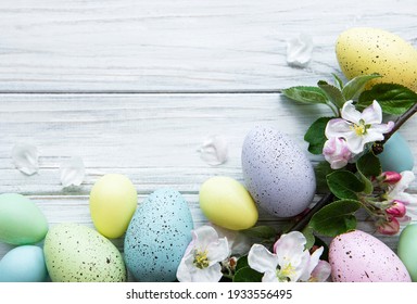 Colorful Easter Eggs With Spring Blossom Flowers Over Wooden Background. Colored Egg Holiday Border.