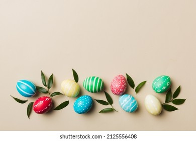 Colorful Easter eggs with spring flower leaf isolated over white background. Colored Egg Holiday border. - Shutterstock ID 2125556408