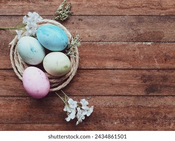 
 colorful eggs in straw nest and  wooden background with space for text - Powered by Shutterstock