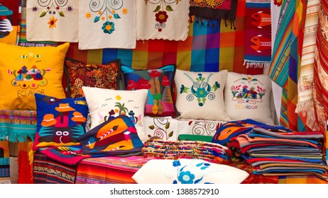 Colorful and embroidered textiles and pillows at the Artisan's Market in Otavalo, Ecuador - Shutterstock ID 1388572910