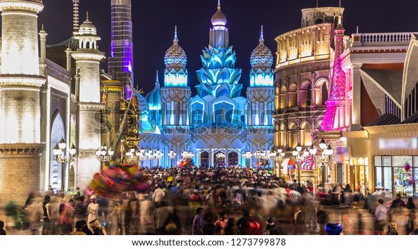 Colorful Entrance to Global Village with\
crowd  in Dubai, UAE. Brightly colouredl lights and highly detailed\
pavilion facades have helped make Global Village one of Dubai\'s\
most popular\
attractions