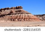 A colorful,  eroded  bentonite mesa  and a  sandy wash on a sunny spring day  along a four wheel drive road near  fossil point in the san rafael swell south of green river, utah