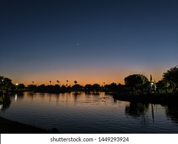 Colorful Evenings At Steele Indian School Park - The Sky And Water Shows Shades Of Blue And Orange.
Also Spot A Crescent Moon With Beautiful Sunset Sky Background- Moon Rise At Sunset.