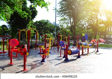 Colorful exercise equipment in public park under sun light in the morning