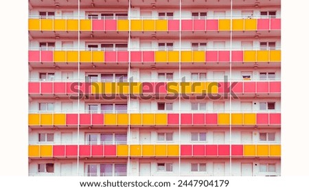 Colorful facade of socialistic estate house with red and yellow balcony detail cut out front view with borders