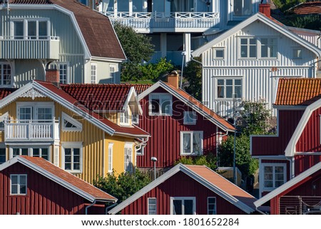 Colorful facades of Swedish summerhouse and rooftops in archepelago of West coast Sweden, Bovallstrand by the Sea.