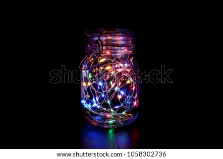 Colorful Fairy Light in a Glass Jar, in the Dark, Low-Key Photography