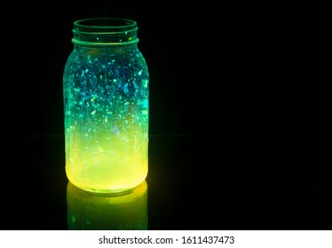 Colorful fairy lights in a glass jar in the dark, copy space. - Powered by Shutterstock