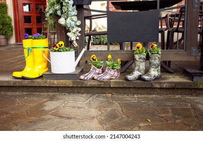 Colorful Family Rain Boots With Flowers On A Rainy Day Outdoors, Horizontal, 