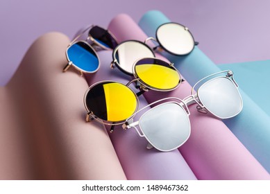 A Lot Of Colorful Fashion Sunglasses  Put On Colorful Pastel Paper Background