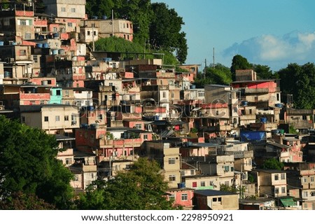 A colorful favela overlooking the Atlantic ocean in Rio de Janeiro. Beautiful sunrise view to favela on hillside in Rio de Janeiro