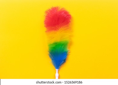 Colorful Feather Duster On Yellow Background. Cleaning Concept.