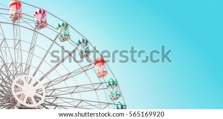 Colorful ferris wheel of the amusement park in the blue sky  background.