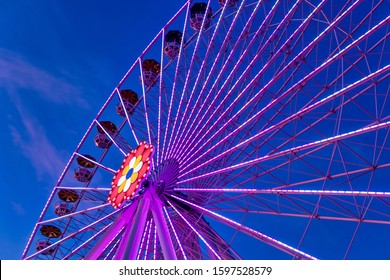 Colorful ferriswheel in vivid neon colors and a dark blue sky. Praten, Vienna