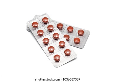 Colorful film coated round tablet NSAIDS pills in transparent blisters silver strip packs isolated on white background with copy space. Drug use in anti-inflammatory and pain. Selective close up focus
