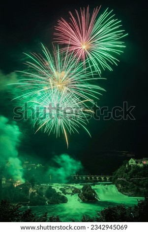 Colorful firework over the Rhine Falls to celebrate traditionally the Swiss National Day on 1. August