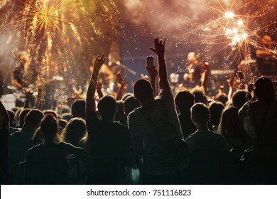 Colorful fireworks and crowd celebrating the New Year - Shutterstock ID 751116823