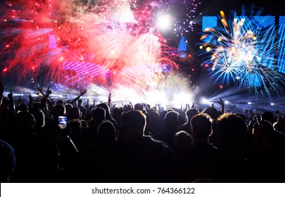 Colorful fireworks and crowd celebrating the New Year - Shutterstock ID 764366122