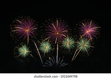 Colorful fireworks on the black sky, anniversary celebration.