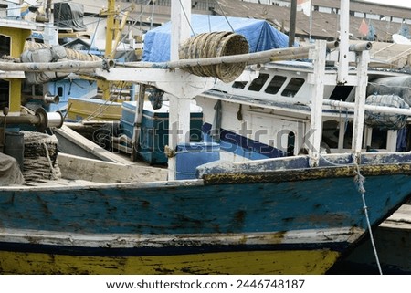 Colorful fishing vessels with equipment at harbor