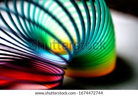 colorful flexible bouncy plastic spring bent into an arch