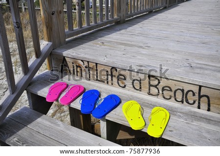 Colorful flip flops on a beach boardwalk