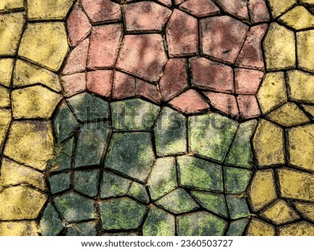 Colorful floor motif of abstract cement bricks. Geometric background pattern of rough cement floor. Paving block motif. Colorful abstract background pattern sidewalk street