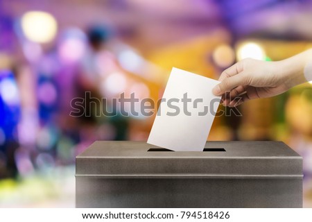 Colorful fo election vote, hand holding ballot paper for election vote concept at colorful background.