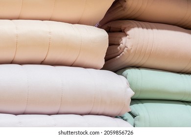 Colorful folded blanket stack closeup picture.