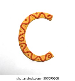 Colorful font fashioned from clay. Letter "C". Isolated letter on a white background.