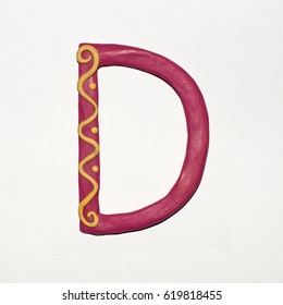 Colorful font fashioned from clay. Letter "D". Isolated letter on a white background.