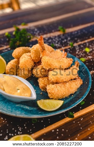 Colorful Food Appetizer Starts Snacks Fresh Delicious Menu Recipe Meal Meat Chicken Fries Fish Seafood Beer on a wooden table on the Beach