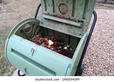 Colorful Food Scraps Fill A Residential Tumbler Style Compost Bin                               