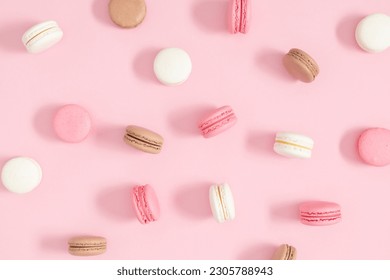 Colorful french desserts. Cake macaroons or macaroon on pink background, colorful almond cookies, pastel colors, macaroon for sweet break mock up. Flat lay, top view