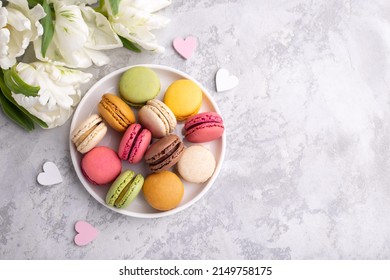 Colorful french macarons on grey stone background traditional dessert in France