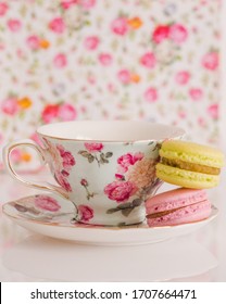 Colorful French Macarons Stacked Next To Floral Fancy Teacup