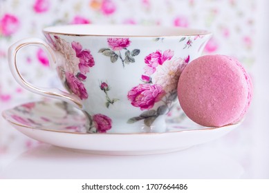 Colorful French Macarons Stacked Next To Floral Fancy Teacup