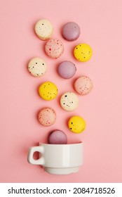 Colorful French Sweet Macarons Fall In White Cup On Pink Background