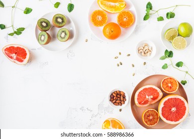 Colorful Fresh Fruit On White Table. Orange, Tangerine, Lime, Kiwi, Grapefruit. Summer Fruit. Flat Lay, Top View, Copy Space