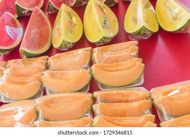 Colorful Fresh Slice Cuts Of Red, Yellow Watermelon And Cantaloupe In Cling Film Plastic Wrap At Market Stand In Singapore. Convenience To-go Or Take Away Healthy Snacks