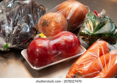 Colorful And Fresh Vegetables In Plastic Bag On The Kitchen Counter, Right After They Were Bought At The Grocery Store. Preparing For Cooking