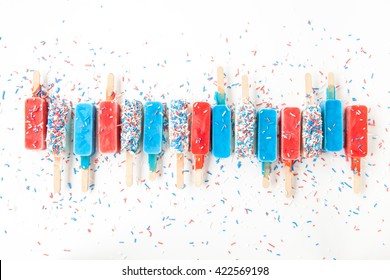 Colorful Frozen Popsicles In Red,white And Blue With Sprinkles