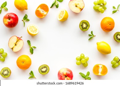 Colorful Fruit Mockup. Cut Apple, Kiwi, Citrus On White Background Top-down Copy Space