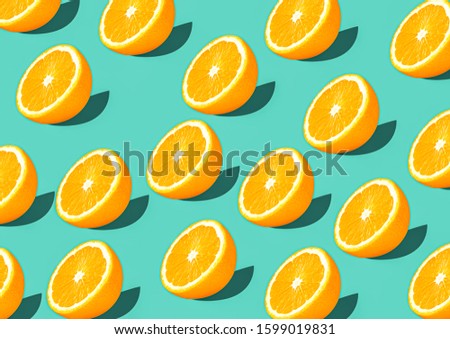 Colorful fruit pattern of fresh orange slices on green background top view
orange fruit pattern background Flat lay orange background cut and full orange