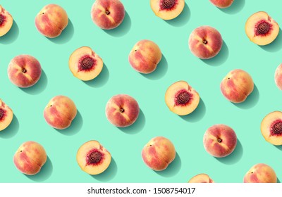 Colorful fruit pattern of fresh peaches on green pastel background
