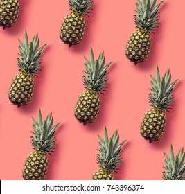 Colorful fruit pattern of fresh pineapples on pink background. From top view