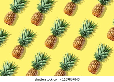 Colorful Fruit Pattern Of Fresh Whole Pineapples On Yellow Background