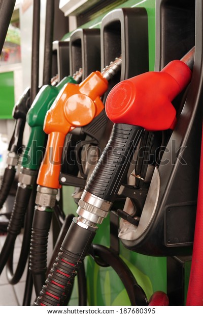 colorful fuel nozzle at gas station, fuel\
dispenser nozzle with hose at petrol\
station